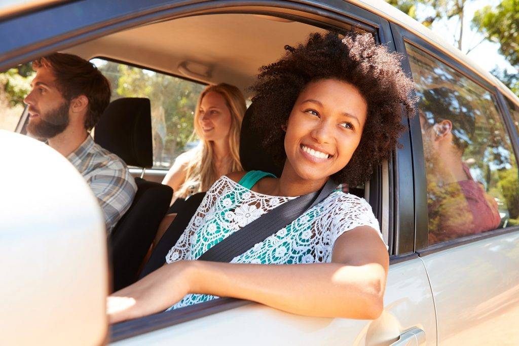 Group Of Friends In Car On Road Trip Together